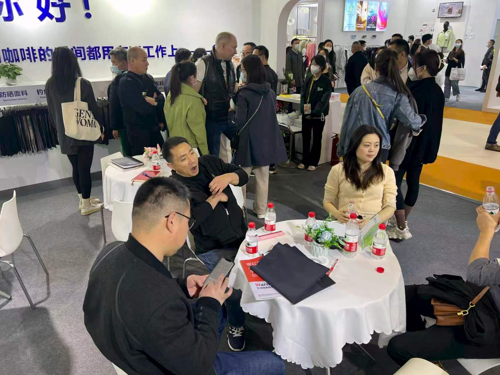 Customer meeting and sample review at textile exhibition